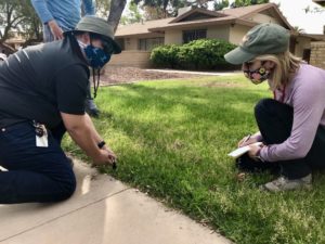 People inspecting sprinkler head.